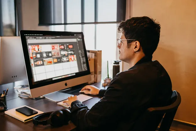 man choosing halloween ad on computer posted by Coheseo