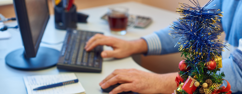 man planning holiday ppc campaign on computer posted by Coheseo