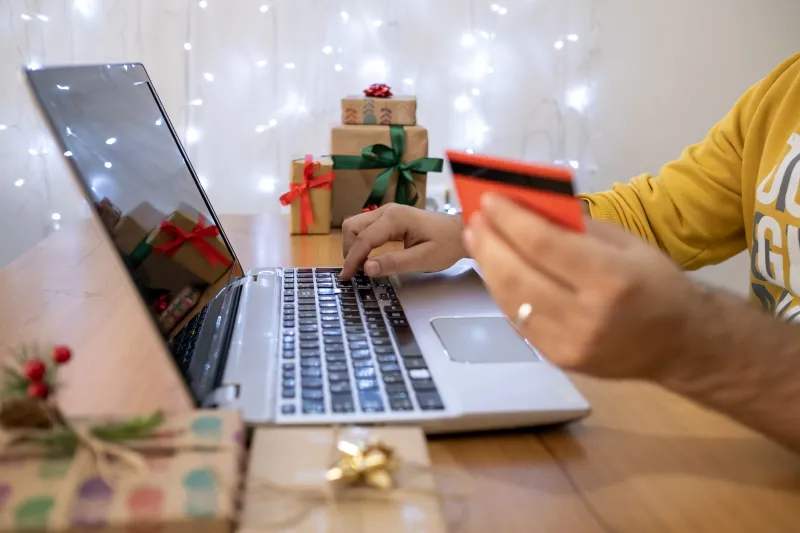 woman checking her computer for christmas shopping posted by Coheseo